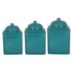 three blue canisters with ornate designs on the top and one has a lid