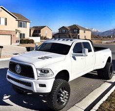 a white truck parked on the side of a road