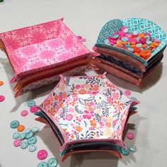 three different types of decorative items on a table with buttons and thread spools