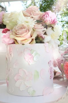 a white cake with pink and white flowers on it