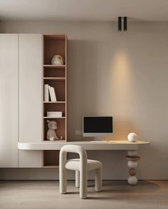 a white desk with a computer on top of it next to a chair and bookcase