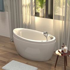 a white bath tub sitting on top of a hard wood floor next to a window