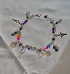 Stray Kids 5 Star LIMITED inspired Beaded Charm Bracelet!  ((all are around 6.5/7" inches long; message me if you need longer Materials used[varies depending on charm]: Acrylic, zinc alloy, stainless steel wire, glass!  CHARM BRACELET CARE! - Please keep in mind that all of my items are intended to be used as an ACCESSORY and NOT a handle or wristlet to hold your phone/wallet/etc. - Excessive pulling on charms may result in breakage - I am not responsible for any damages once the item is in your Metal Charm Bracelet With Star Charm, Customized Silver Beaded Bracelets For Birthday, Trendy Customized Silver Beaded Bracelets, Trendy Metal Charm Bracelet With Star Charm, Trendy Silver Beaded Bracelets For Birthday, Star Charm Bracelet, Long Message, Beaded Charm Bracelet, Stainless Steel Wire