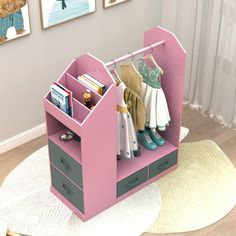 a child's pink toy closet with clothes and toys in it on top of a rug