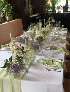 a long table is set with flowers and candles