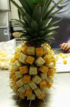 a pineapple is piled with cubes of cheese