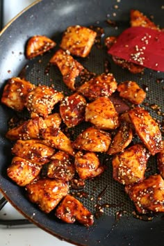 the food is being cooked in the skillet on the stove top with sauce and seasoning