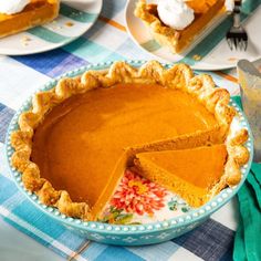 there is a pie that has been cut in half and on the table with plates