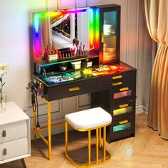 a desk with a mirror, stool and lights on it