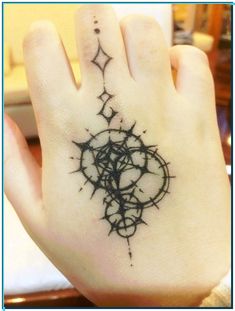 a person's hand with a tattoo on it