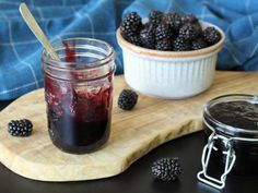 blackberry jam in a jar and fresh blackberries on a cutting board