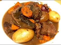 a white plate topped with beef and potatoes