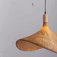 a bamboo light fixture hanging from a ceiling