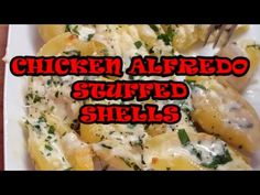 chicken alfredo stuffed shells on a white plate with the words chicken alfredo stuffed shells above it