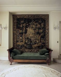 a living room with a couch and tapestry on the wall