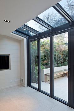 an empty room with glass walls and sliding doors