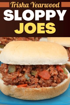 two sloppy joes on a blue plate with text overlay that reads, trisha yearwood sloppy joes