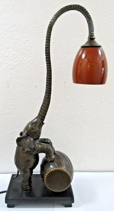 an elephant lamp with a brown shade on it's head