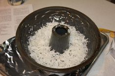 a metal pan filled with white rice on top of a table next to some napkins