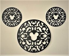 three black mickey mouse coasters sitting on top of a white countertop next to each other