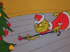 an image of a cartoon character on the ground with christmas decorations around him and trees in the background