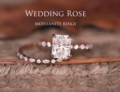 a close up of a diamond ring on top of a piece of wood with the words, wedding rose