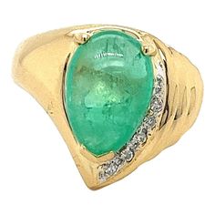 18K yellow gold ring featuring a7.81 carat pear shaped cabochon cut natural green emerald as the center stone. The 7.81 carat emerald showcases a beautiful green hue, and smooth cabochon cut. Adorned with 0.29 carats in round cut diamonds. This ring offers a pear shape design with a 6mm length that elongated the finger when worn. A stunning statement ring with natural gemstones and solid gold.   Item Details: - Type: Ring  - Metal: 18K Yellow Gold  - Weight: 7.2 Grams  - Setting: Prong  - Size: Wide Band Engagement Ring, Vintage Solitaire Engagement Ring, Vintage Sapphire Ring, Purple Diamond, Emerald Diamond Ring, Contemporary Ring, Cabochon Ring, Gold Band Ring, 18k Yellow Gold Ring