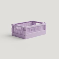 a purple plastic crate sitting on top of a gray surface