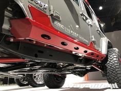 the rear end of a red jeep on display