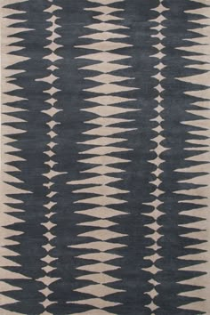 a brown and white rug with an abstract design on the bottom, in front of a white background