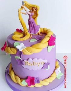 a purple cake with a blonde haired girl on top and flowers around the edges that spell it's name