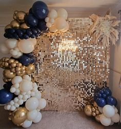 balloons and streamers are arranged in the shape of an arch with gold, white and blue decorations