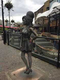 a statue of a woman in a short dress