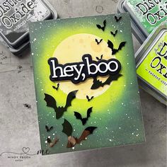 three tins with bats and the word hey boo on them