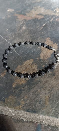 Beautiful black eye catching k crystals with round lava beads. Stylish and sparkly. Goes with so many outfits Lava Beads, Swarovski Crystal Beads, Crystal Beads Bracelet, Lava Bead, Eye Black, Beaded Bracelet, Crystal Beads, Swarovski Crystals, Jewelry Bracelets