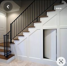 an open door leading to a stairway in a house with white walls and wood steps