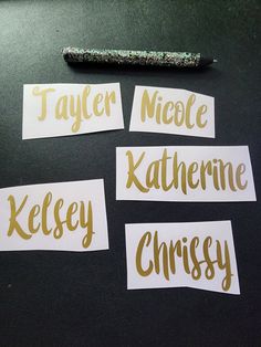 four pieces of paper with gold lettering on them