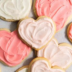 some heart shaped cookies with frosting on them