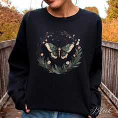 Goblincore Moth and Flowers Unisex Crewneck Sweatshirt | Botanical Grunge Moth Jumper | Dark Cottagecore Aesthetic Autumn Jumper  ✔️ Super comfy unisex heavy blend crewneck sweatshirt  ✔️ 50% cotton 50% polyester ✔️ Medium-heavy fabric (8.0 oz/yd² (271.25 g/m ✔️ No side seams ✔️ Ribbed knit elastic collar to help collar retain its shape ✔️ Sewn-in label 📏 Runs true to size ✨ Care instructions: Machine wash: cold (max 30C or 90F). Turn inside out before washing to protect the print. Non-chlorine Black Fairycore Crew Neck Top, Fairycore Crew Neck Top For Fall, Dark Cottagecore Aesthetic, Moth Sweater, Autumn Jumpers, Lover Clothes, Aesthetic Autumn, Dark Cottagecore, Cottagecore Aesthetic