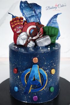 the cake is decorated with captain america and other things on it's top tier