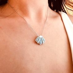 Experience the beauty and tranquility of the ocean with our Ocean clam shell Larimar pendant necklace. Handcrafted with 925 sterling silver, this necklace features a stunning Larimar pendant in the shape of a clam shell. The perfect accessory for any lover of the sea, this necklace also comes with a sterling silver cable chain for a complete and elegant look. Bring a touch of the ocean with you wherever you go! Materials: 925 sterling silver, LarimarFinish: platinum plateChain style: CableChain length: 18 +1.5 in adjustable lengthPendant dimensions: 0.72 x 0.63 in Jewelry Care: See more information about how to care for your jewelry here. Shipping Policy: Orders will be shipped within 1-3 business days. Economy shipping will take 7-14 days to arrive and standard shipping is 1- 4 days for U Larimar Pendant, Silver Jewelry Earrings, Handmade Fashion Jewelry, Clam Shell, Screw Back Earrings, Cable Chain, Jewelry Earrings Studs, Silver Charms, Ring Necklace