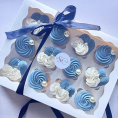 blue and white cupcakes in a gift box