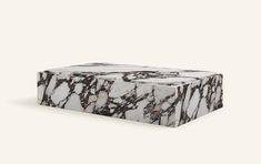 a white and black marble box sitting on top of a table