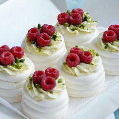 small desserts with raspberries and whipped cream on a white platter, ready to be eaten