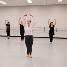 a group of women standing on top of a dance floor in front of each other