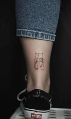 a woman's foot with a small tattoo on it