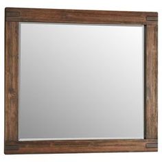 a wooden framed mirror on a white wall