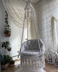 a white hanging chair in the corner of a room