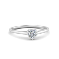 This 1.50 Carat Heart Shaped Bezel Set Ring incredibly portrays sheer elegance with a gorgeous heart-shaped diamond with impeccable brilliance accented in a classic bezel setting on the sleek and delicate shank of the ring adding a verve of charm and grace.  Heart shaped center stone of 1.50 Total Carat Weight with Clarity SI1 and Color G in a bezel setting. The 1.50 Carat Heart Shaped Bezel Set Ring can also be acquired with various other valuable metals. Free Shipping Within USA. One Year Manufacturing Warranty. Easy Returns With Lifetime Upgrade. GIA Certified Diamonds. Work with our in-house CAD designers, craftsmen and GIA graduated gemologists to design your custom engagement rings. Designers at our New York Showroom will start with your ideas, wants and budget and together we w Half Carat Diamond Ring, Solitaire Halo Engagement Ring, Bezel Set Wedding Ring, Heart Engagement, Moissanite Engagement Ring Halo, Heart Engagement Rings, Custom Engagement Rings, Diamond Heart Ring, Bezel Set Ring