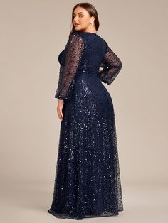 a woman in a long blue dress with sequins